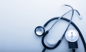 stethoscope on blue background with space for simple text